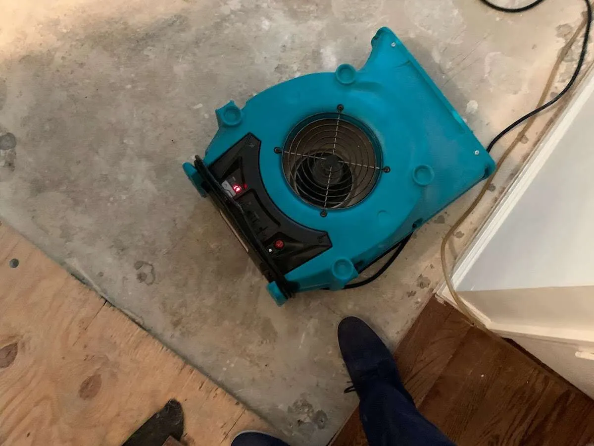 Air mover drying subfloor during Commercial Water Damage Restoration in Altoona